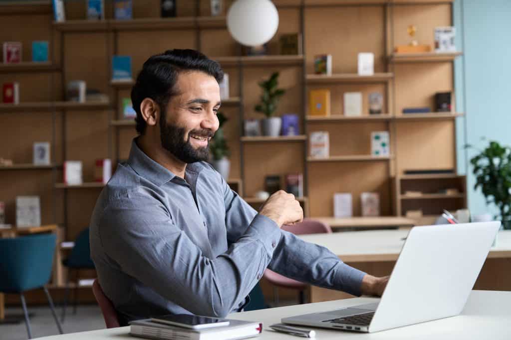 Happy Indian Professional Young Adult Man Having Video Conferenc